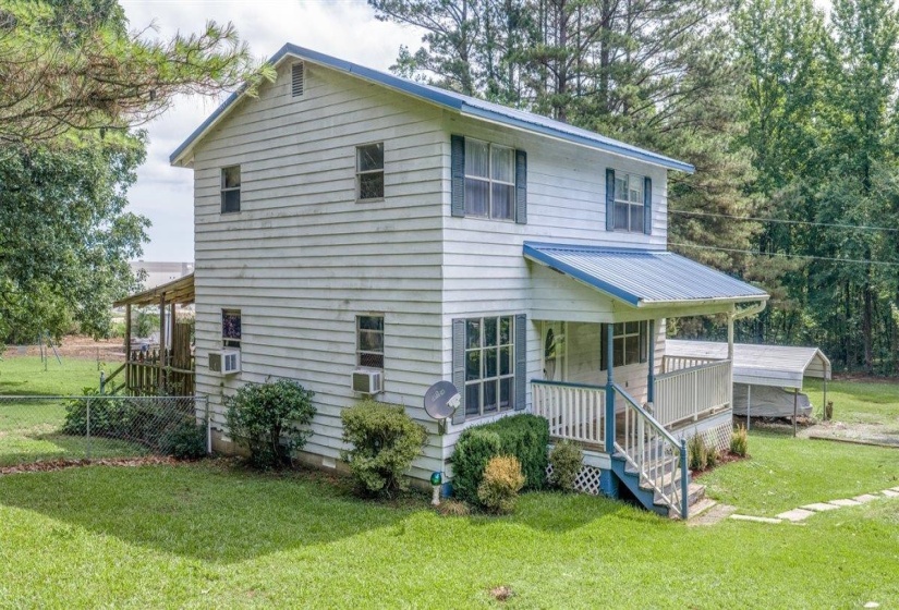 Two-story residence featuring a blue metal roof and white siding