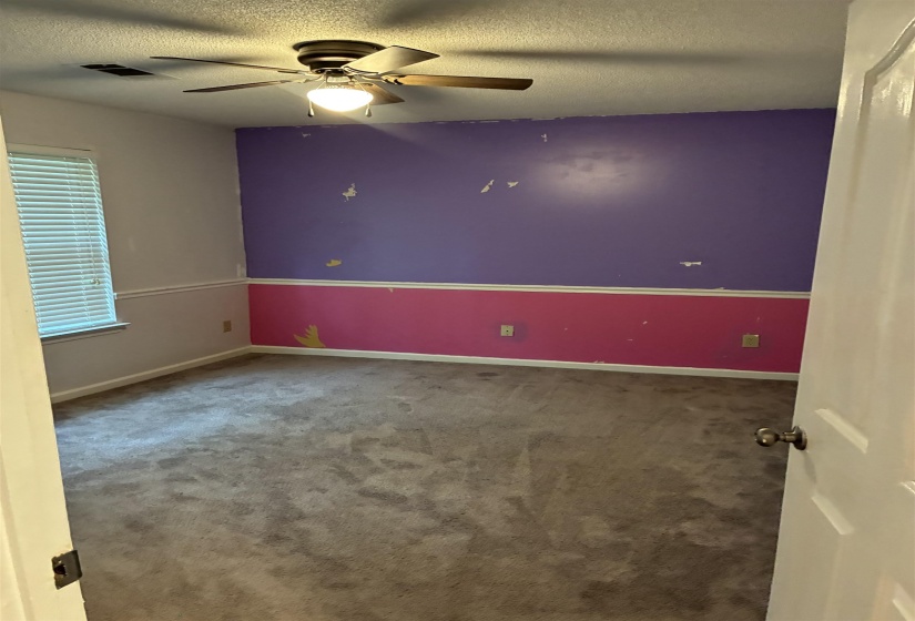 Interior room featuring wall-to-wall carpeting and a ceiling fan with integrated lighting