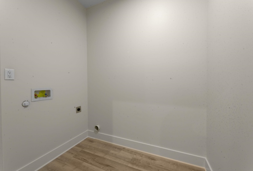 Laundry area featuring light wood-style flooring, hookup for an electric dryer, and hookup for a washing machine