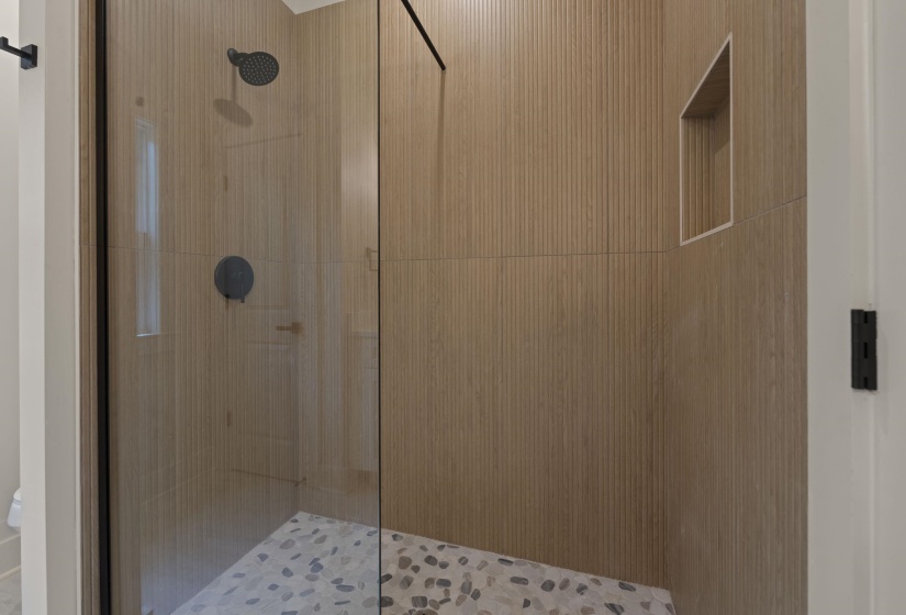 Full bathroom with a shower stall and toilet