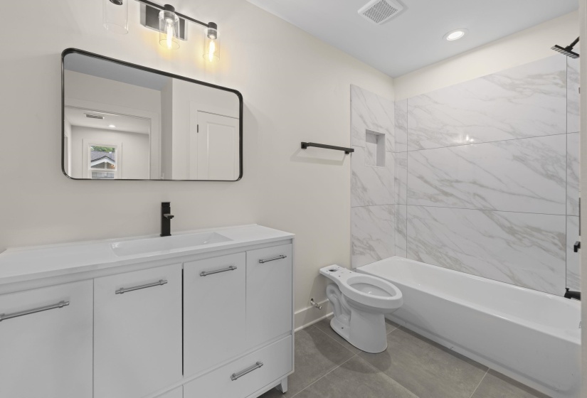 Full bathroom featuring vanity, shower / washtub combination, recessed lighting, and dark tile patterned flooring