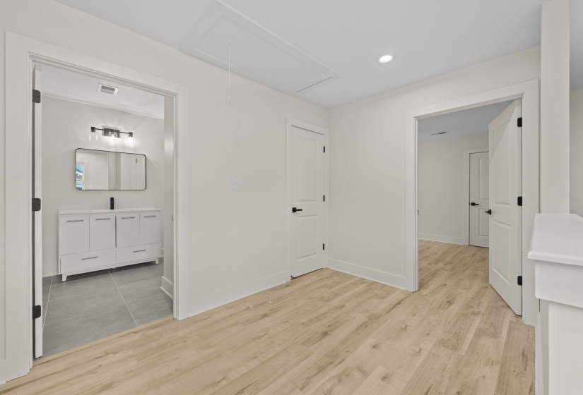 Corridor featuring light wood-style flooring and recessed lighting