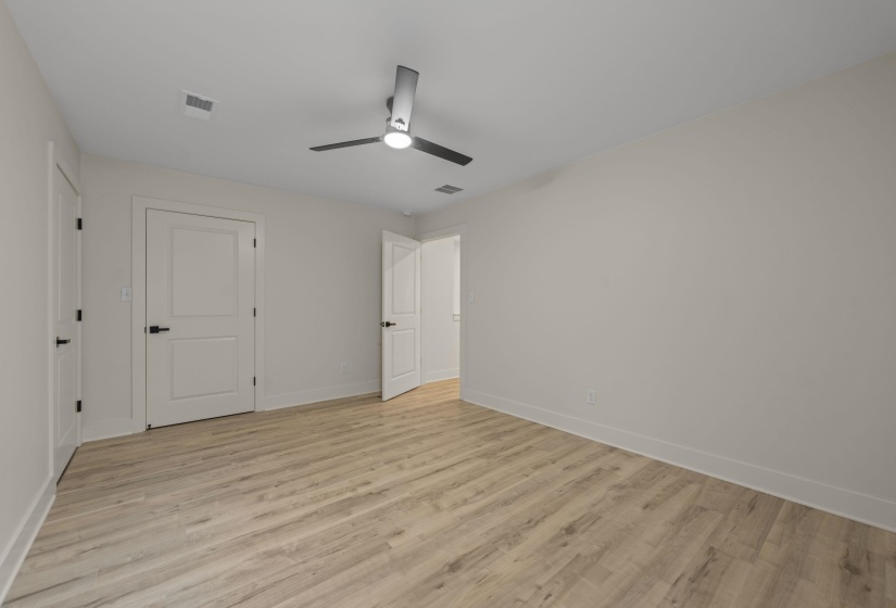 Unfurnished bedroom featuring light wood-style flooring and a ceiling fan
