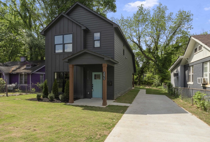 View of front of home featuring board and batten siding and concrete driveway
