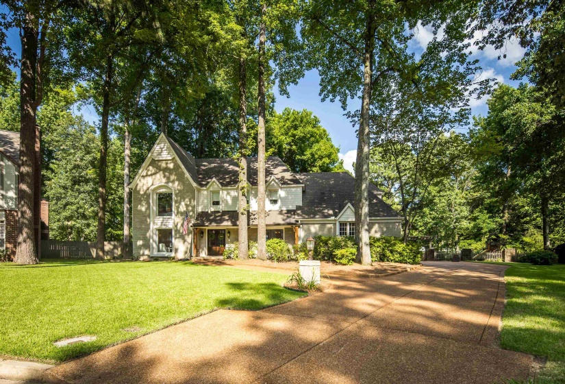 Stately stucco exterior with a prominent gabled architectural feature