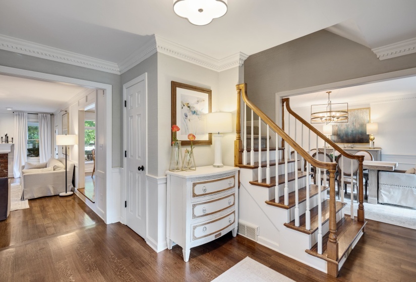 Central staircase featuring wood-finish treads and handrails with white balusters