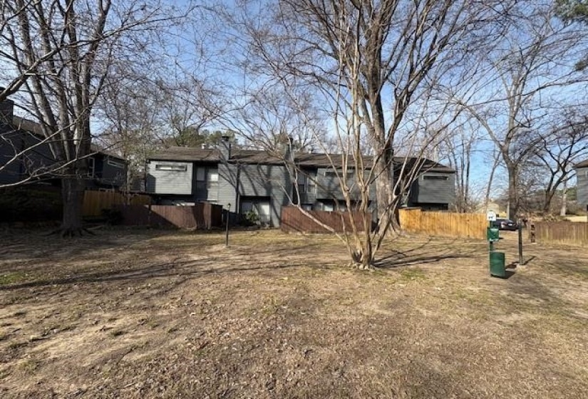 Backyard features a private wood fence and established trees