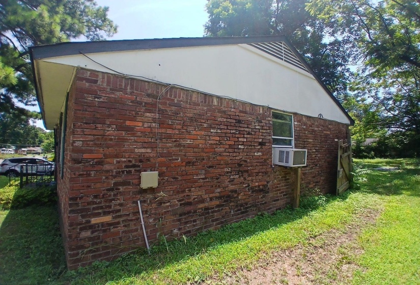 Brick exterior with white siding and a sloped roofline