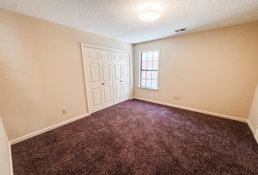 Room featuring beige walls and deep pile carpet