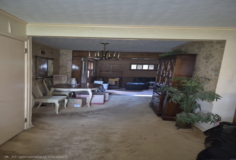 Carpeted entryway leading into an open-concept living area with a visible chandelier