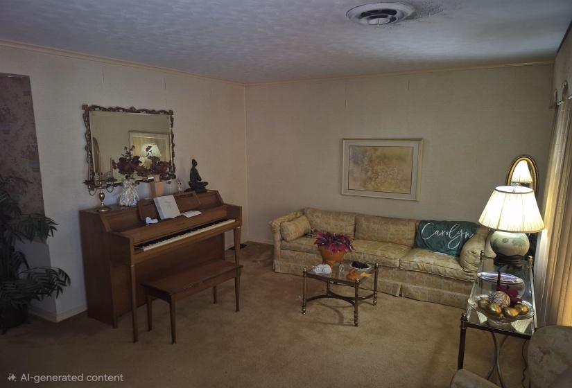 Carpeted interior space featuring a textured wall panel, decorative framed mirror, and crown molding