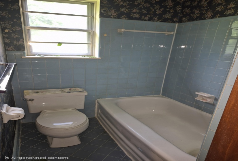 Bathroom featuring a bathtub, toilet, and a window