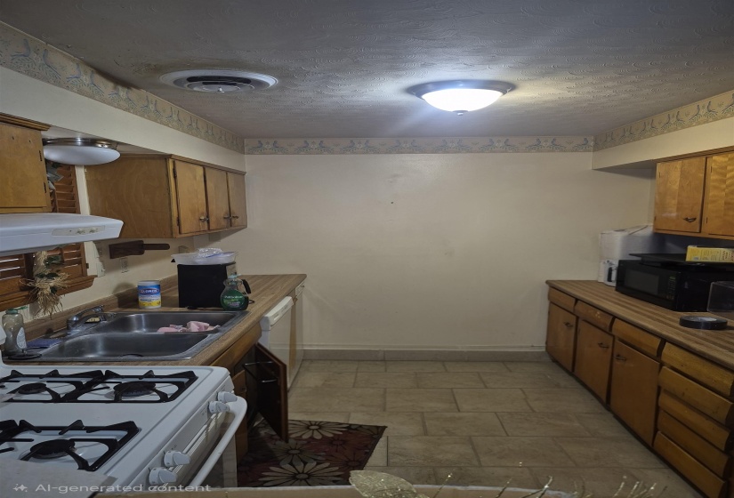 Kitchen featuring wood cabinetry, laminate countertops, a stainless steel double sink, and tiled flooring