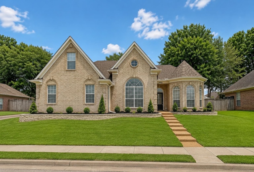 Brick exterior with gabled rooflines and a rounded turret feature