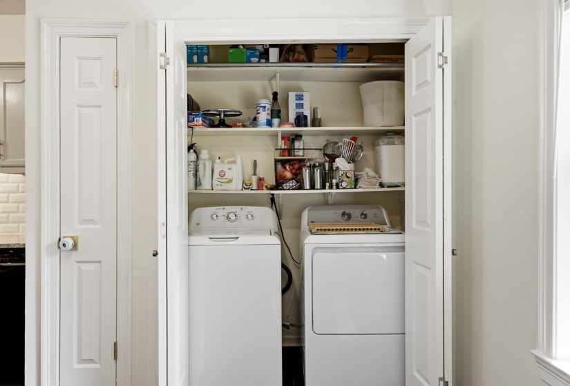 Dedicated laundry closet featuring a top-load washing machine and a front-load dryer