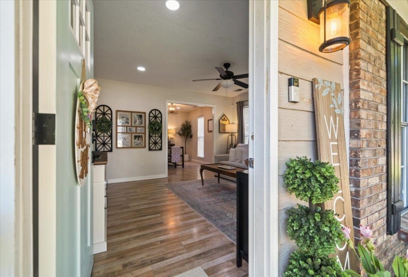 Front entry with light wood-finish flooring, recessed lighting, and a ceiling fan