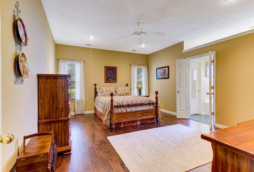 Spacious room featuring rich wood-finish flooring and a neutral color palette