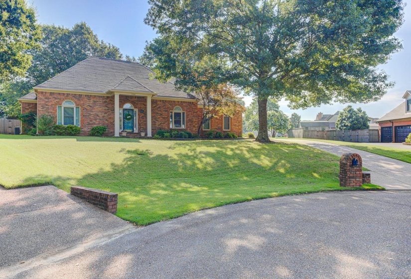 Brick exterior residence with a prominent front entrance featuring white columns
