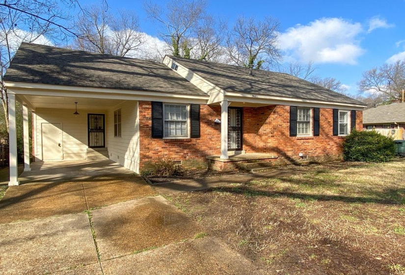 Brick exterior with black shutters and a covered carport