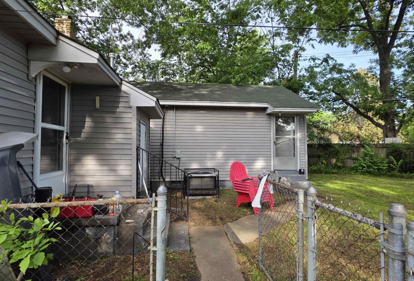 Rear exterior with grey horizontal siding and a green shingle roof