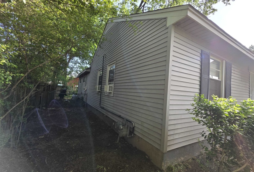 Exterior siding with dark shutters and a deep overhang