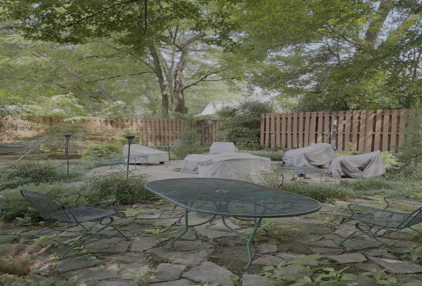 Spacious outdoor area featuring a stone patio