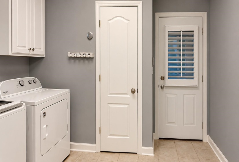 Dedicated laundry area featuring tile flooring and white cabinetry