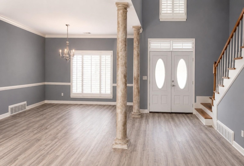 Entryway featuring dual white doors with oval glass inserts and transom windows