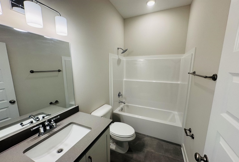 Full bathroom with vanity, shower / tub combination, tile patterned floors, and recessed lighting