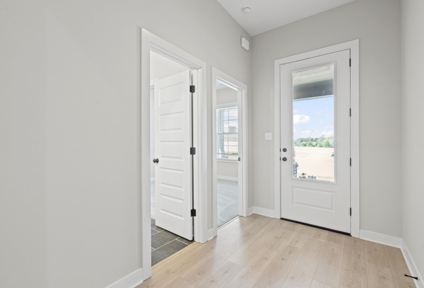 Doorway to outside with baseboards and wood finished floors