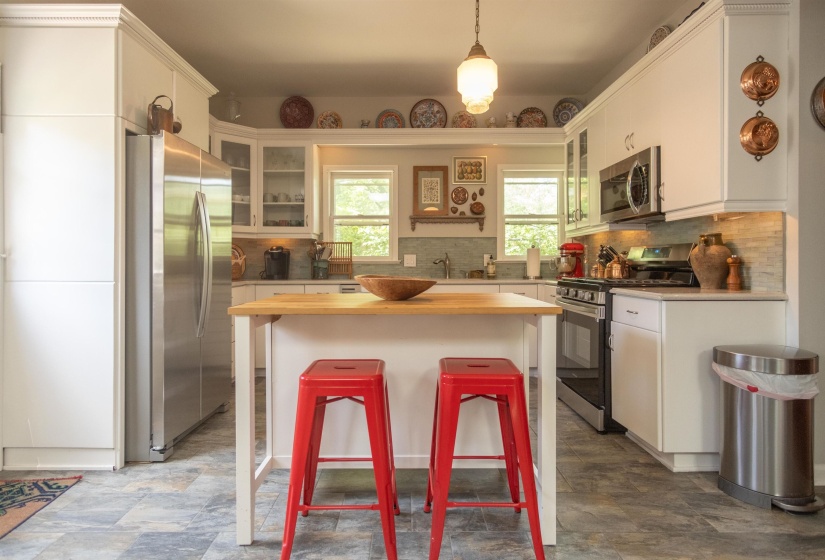 White cabinetry and stainless steel appliances define this kitchen space