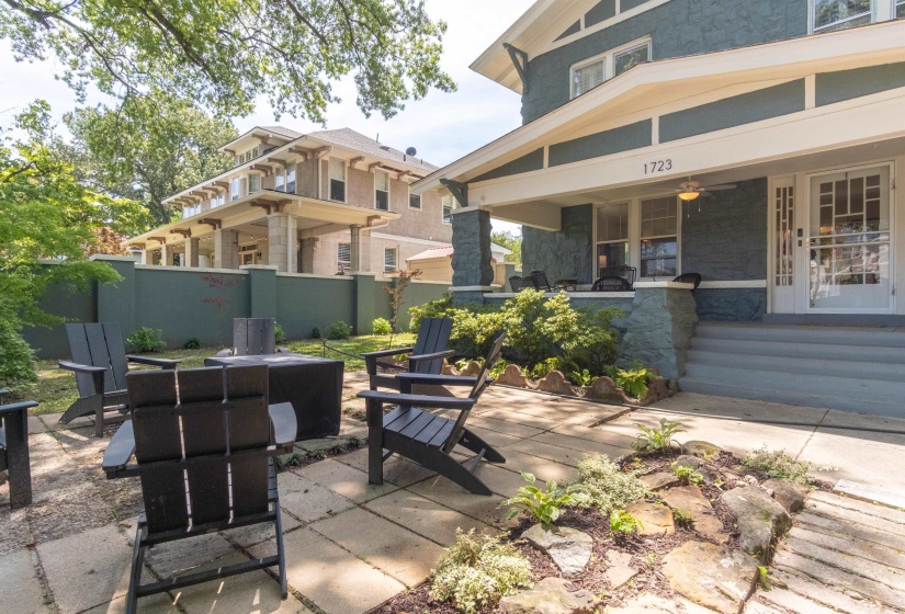 Paved patio area featuring a fire pit and integrated landscaping