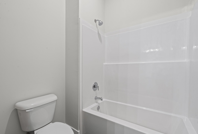 Bathroom with bathtub / shower combination and toilet