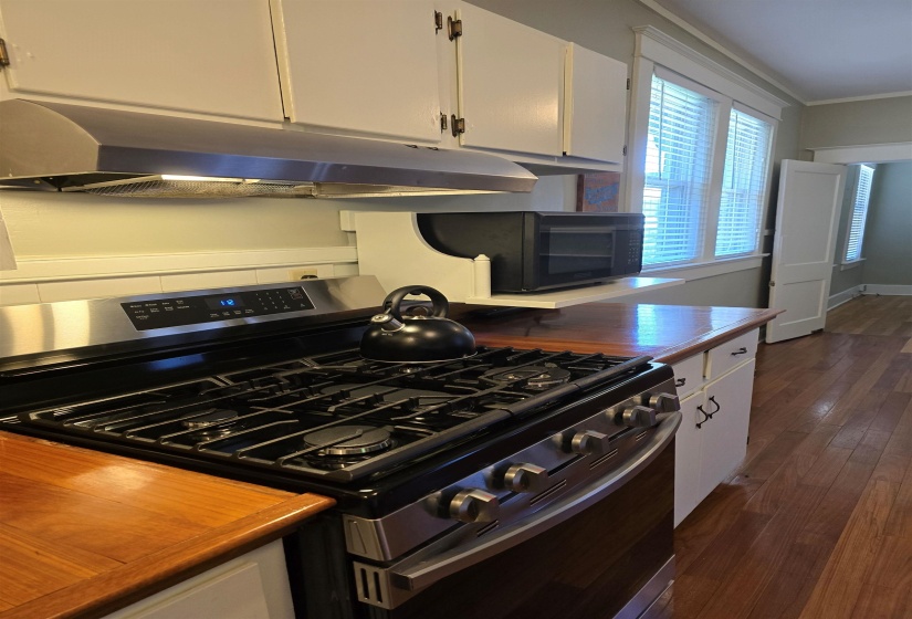 Both Counters and Flooring are Brazilian Cherrywood. ... White cabinetry, ornamental molding.