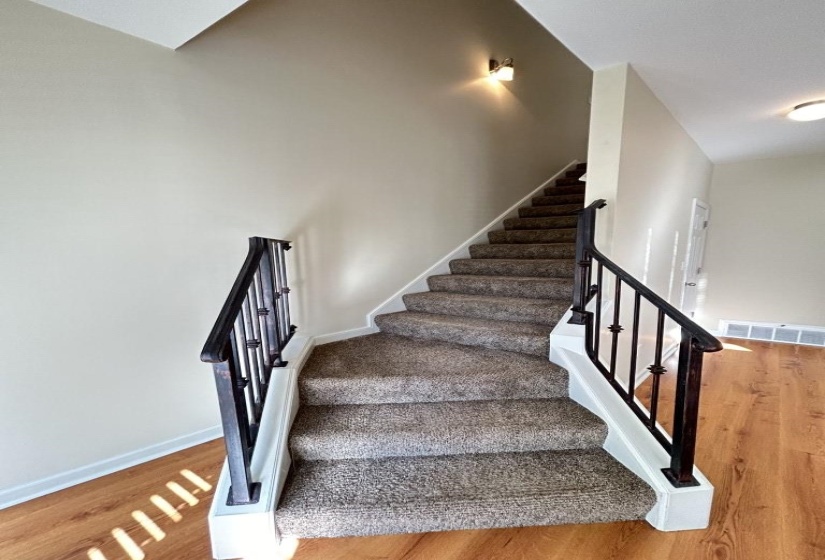 Stairs featuring wood-type flooring