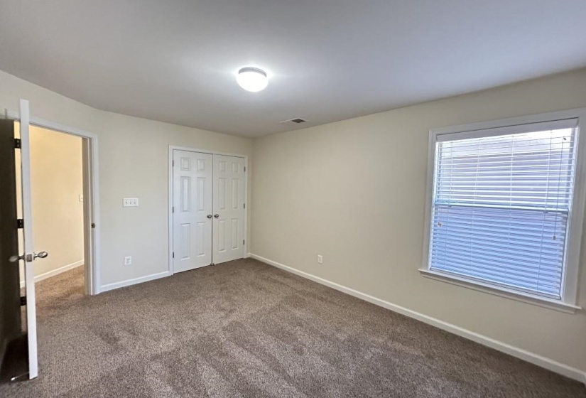 Unfurnished bedroom featuring a closet and carpet flooring