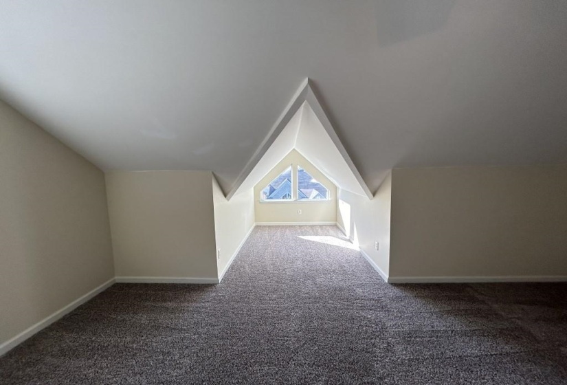 Bonus room featuring carpet and vaulted ceiling