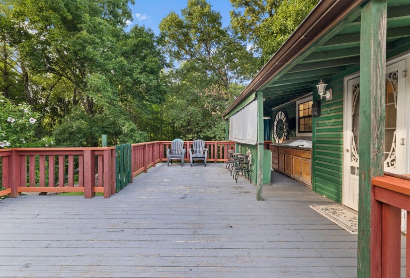 Expansive outdoor deck featuring wood flooring and a perimeter railing
