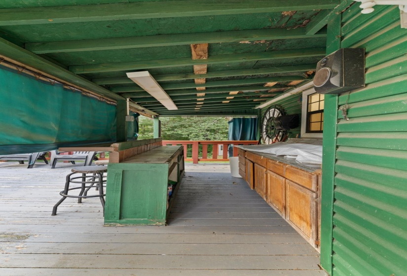 Covered wooden porch with exposed rafters