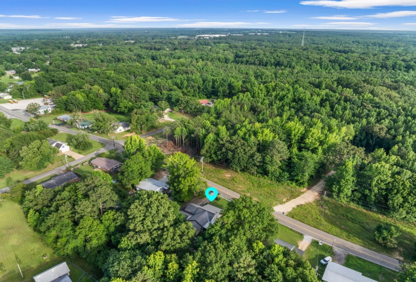 Expansive wooded acreage featuring a cleared building site and established road frontage