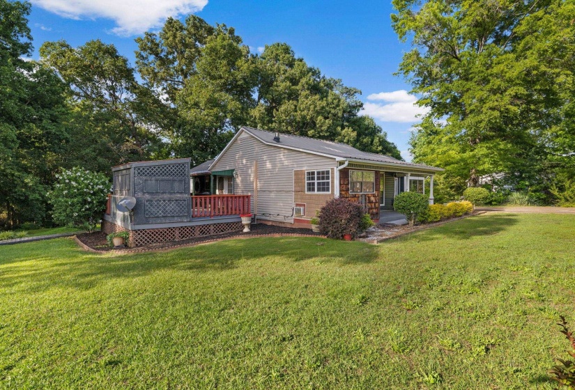 Exterior featuring a metal roof, beige siding, and a covered front porch
