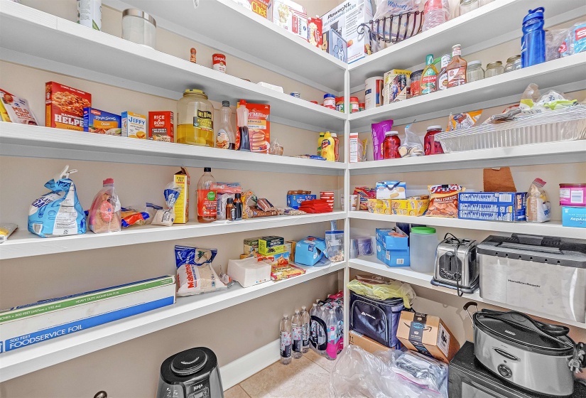 Spacious pantry with extensive built-in shelving, providing ample storage capacity