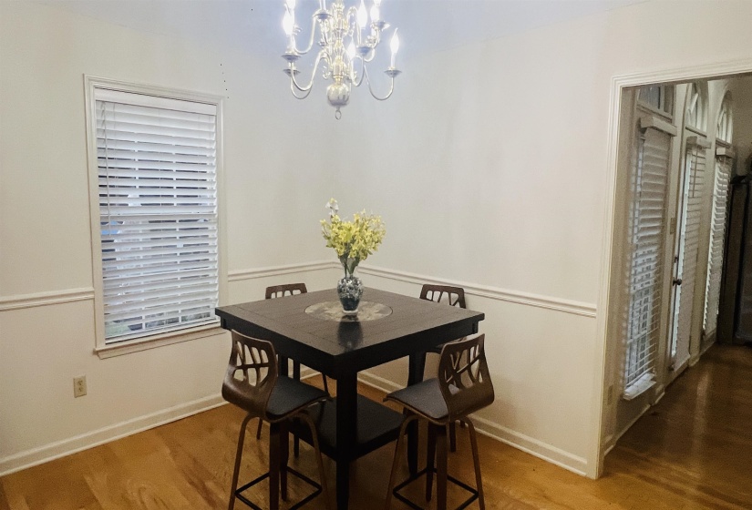 Dining area featuring hardwood flooring and a decorative chandelier
