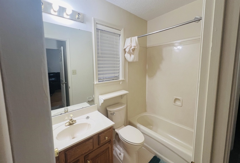 Bathroom featuring a vanity with wood cabinetry, a white countertop, and an integrated sink