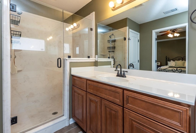 Spacious bathroom featuring an updated wood vanity.