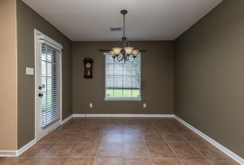 Lots of Light, Tiled and  has door that opens to patio and spacious backyard.