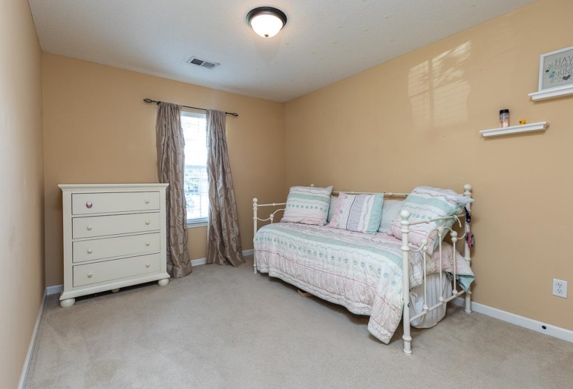 Room featuring light beige wall paint, a single window with drapes, and a ceiling-mounted light fixture, Extra Large Almost Walk-In Closet.