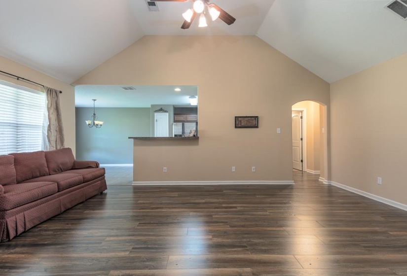 Spacious great room/entrance to Eat-In Kitchen. GR has vaulted ceilings, LVP flooring, and neutral wall tones