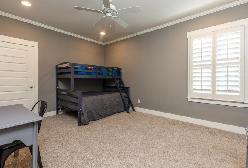 Carpeted room featuring a ceiling fan with integrated lighting, recessed overhead lighting, and white crown molding