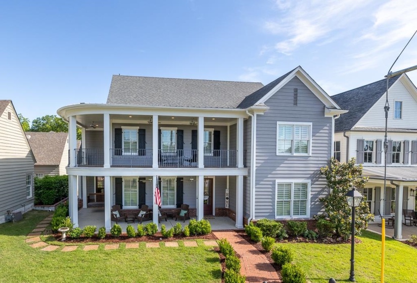 Two-story home with a prominent curved second-story balcony